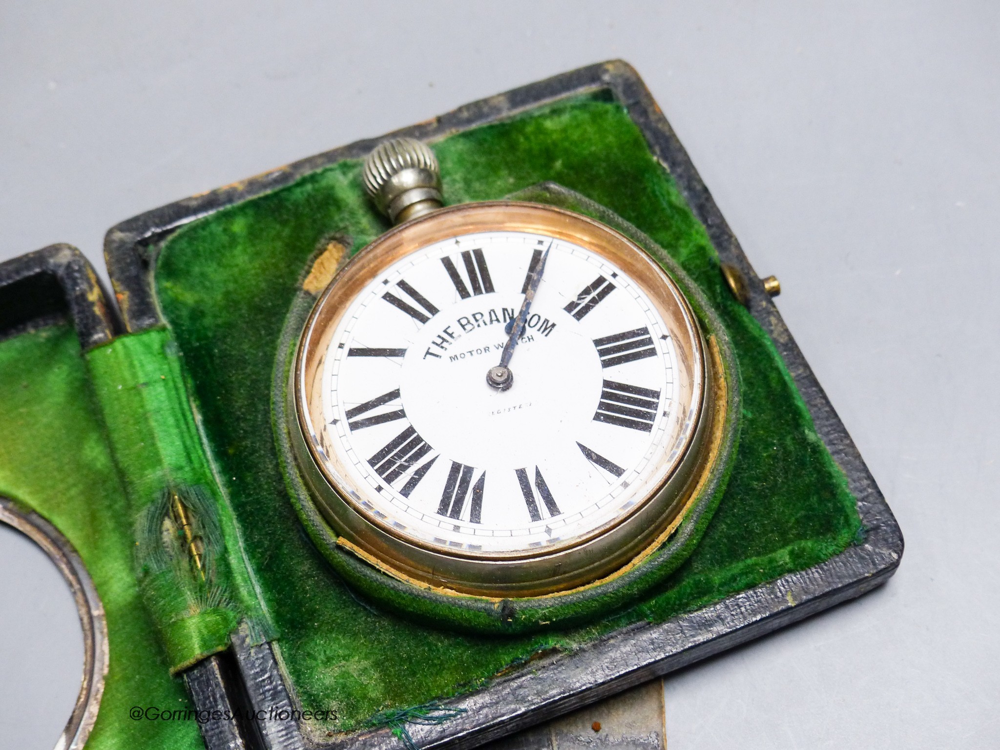 A cased carriage clock and a silver mounted motorwatch
